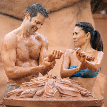 A couple enjoys the rejuvenating skin benefits of red clay at the mud bath at Glen Ivy.