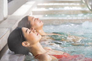 Two women relaxing and soaking in Epsom salt bath at Glen Ivy Hot Springs