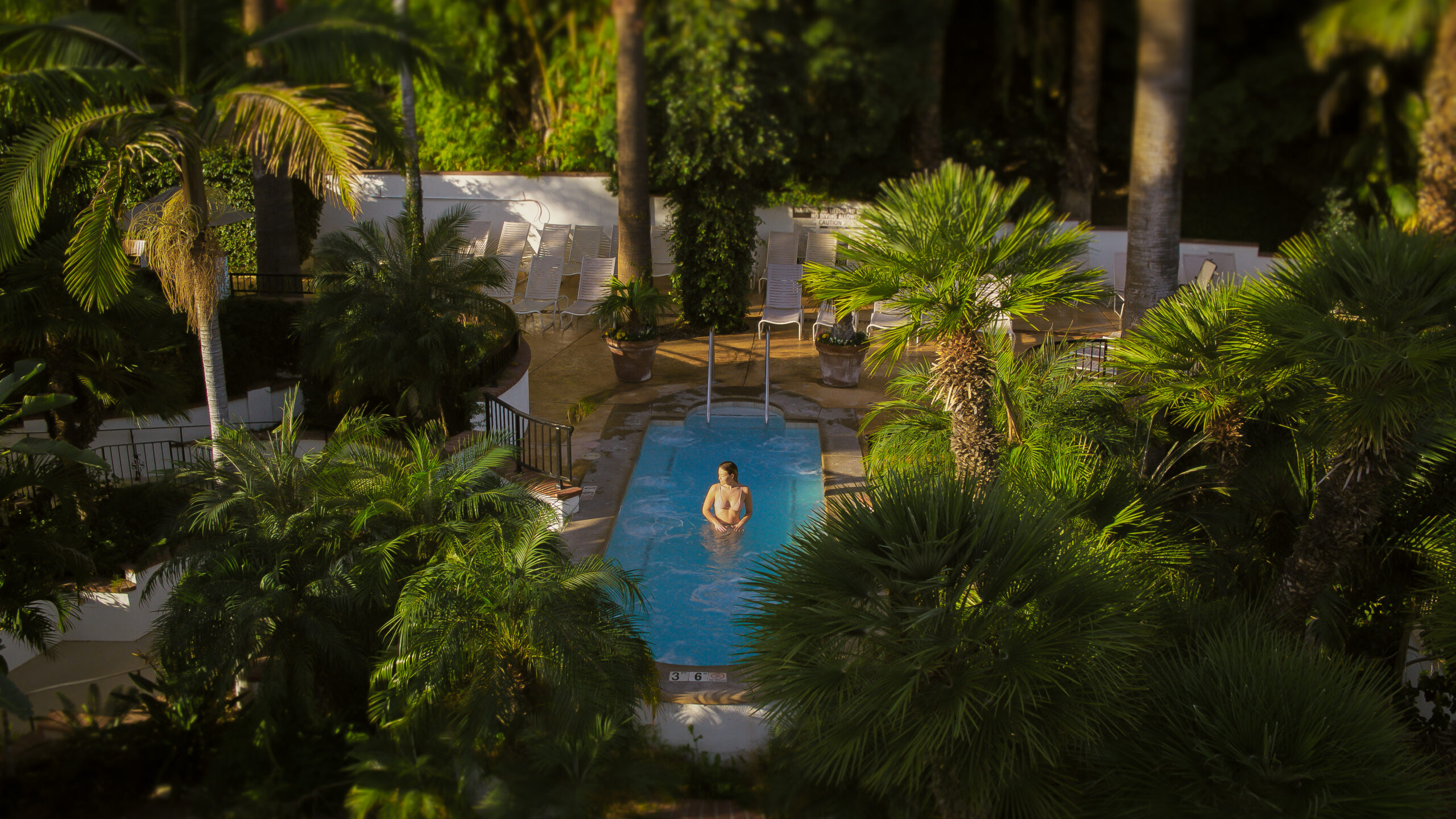 Woman swimming in hot spring surrounded by nature at Glen Ivy Hot Springs.