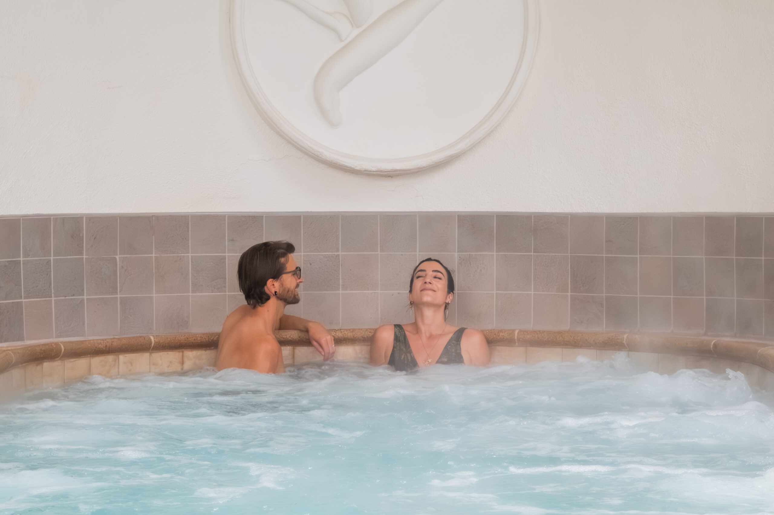 Two people enjoy a hot saline bath at Glen Ivy Hot Springs in honor of Soakember.