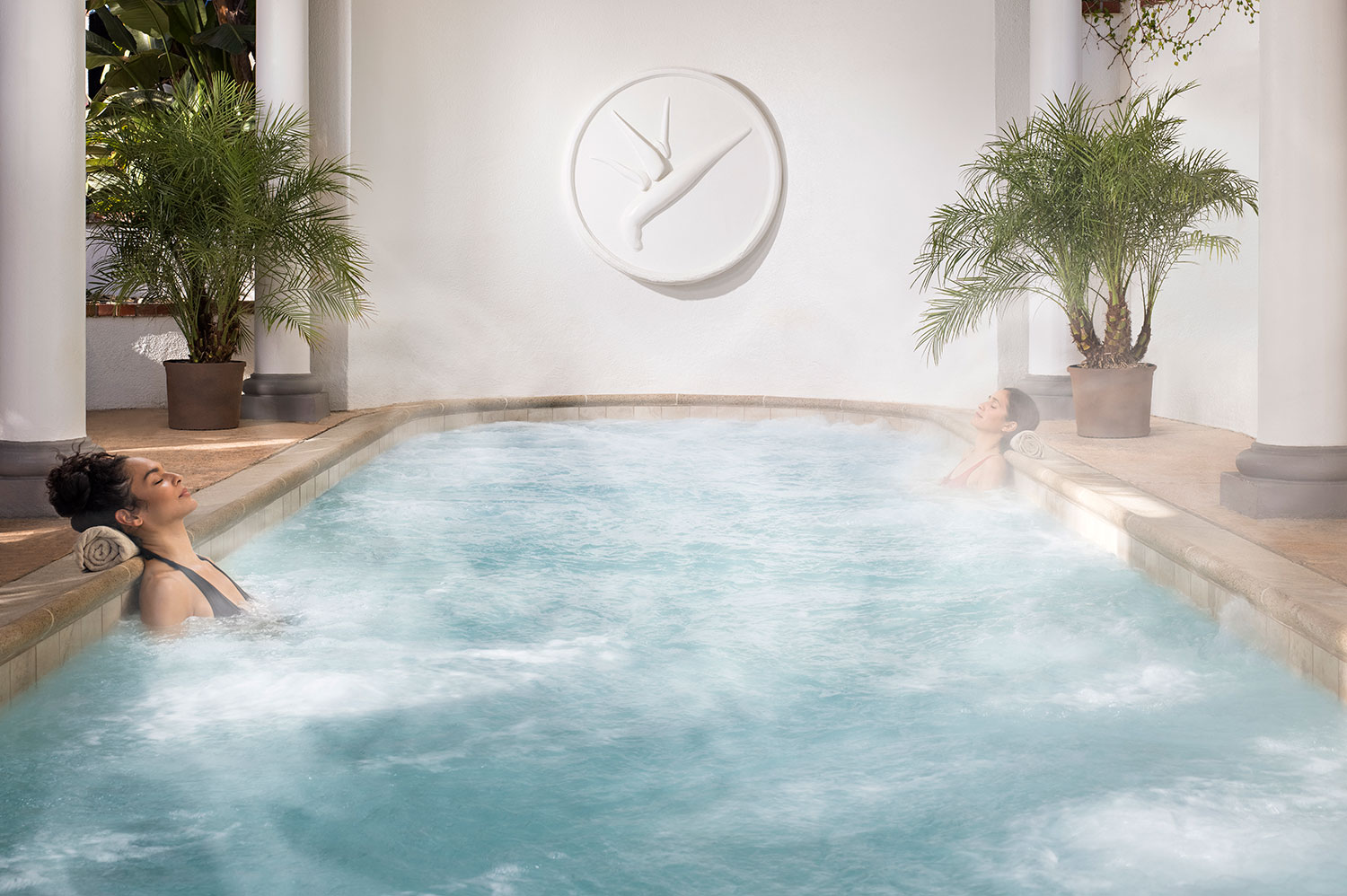 Two women soak in hydrothermal therapy pools at Glen Ivy Hot Springs.